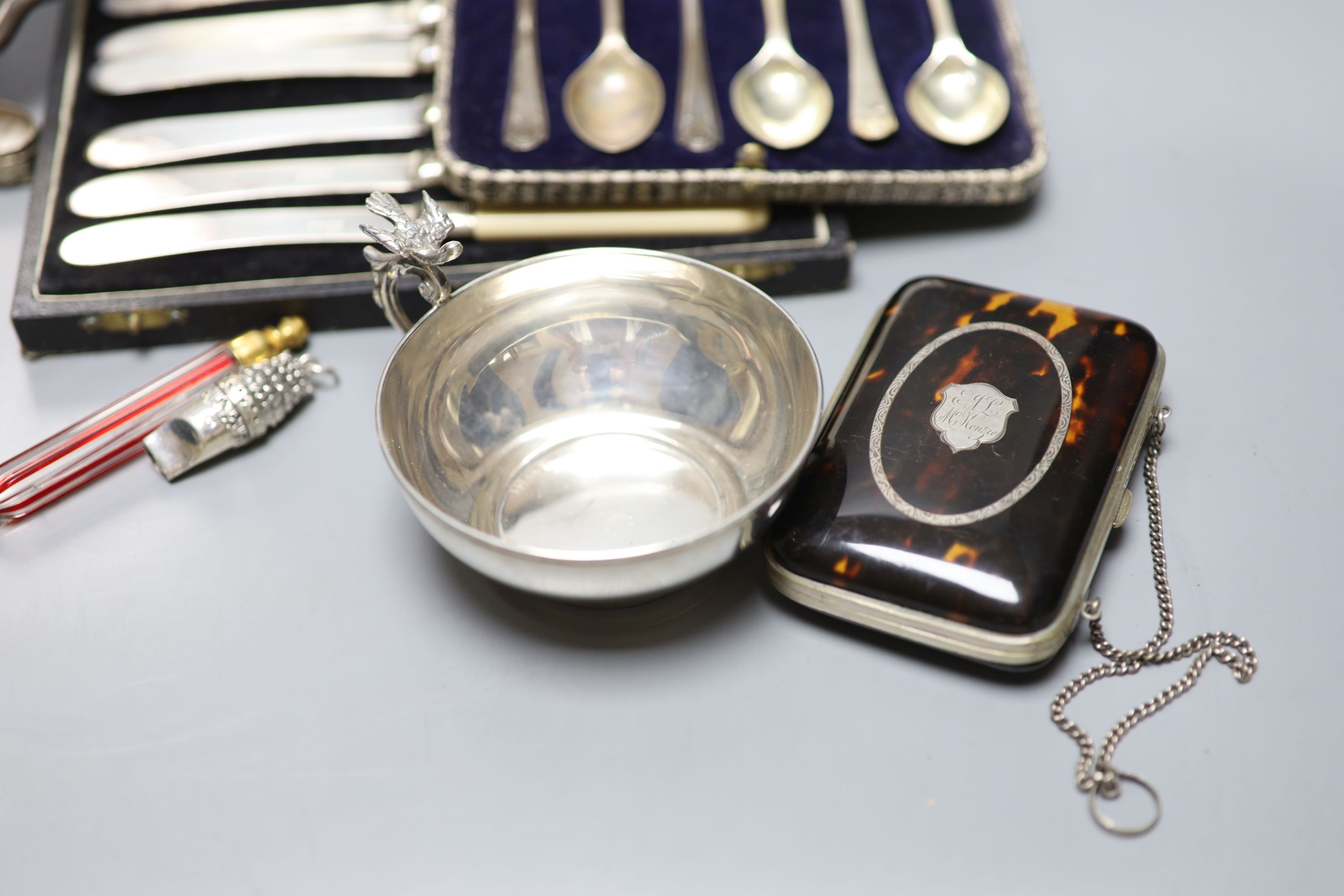 Mixed small silver and plated wares including sterling cup, repousse silver boxes, cased silver teaspoons, silver card case, 925 whistle, plated Art Nouveau aide memoire, plated salver etc.